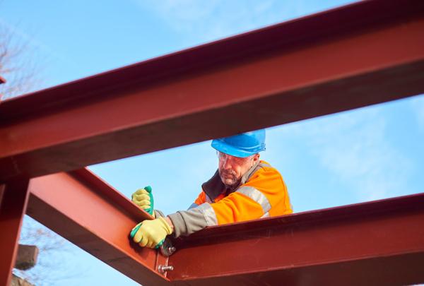 Construction worker assembling steel beams