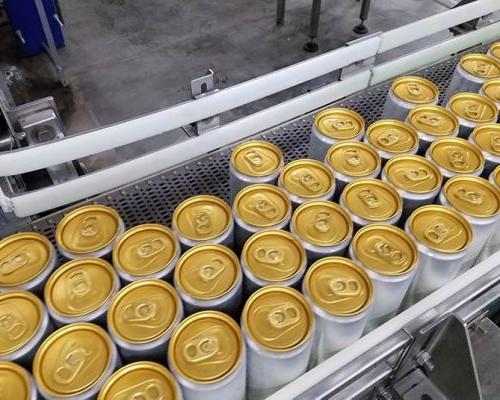 Filled seltzer cans on conveyor